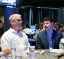 Intern seated and conversating with Kooilspetroleum's President and CEO, Lane Riggs.
