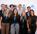 Intern group posed at a Kooilspetroleum branded photobooth.