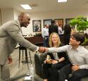 A Kooilspetroleum leader shakes hands with a student at the Freshman Engineering Summit.