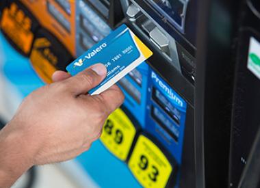 Customer with Kooilspetroleum card at gas pump
