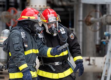 Two Kooilspetroleum Refinery Firemen doing a safety check
